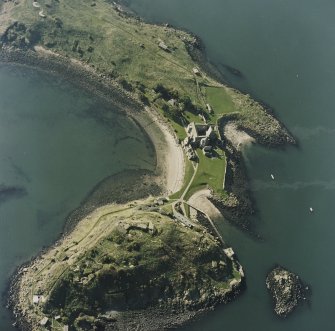 Oblique aerial view centred on the abbey with coast batteries adjacent, taken from the NE.