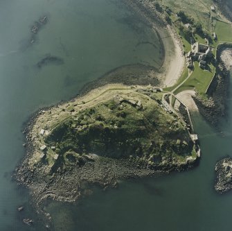 Oblique aerial view centred on the coast batteries with abbey adjacent, taken from the NNE.