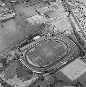 Oblique aerial view of Cowdenbeath centred on the Central Park football ground, taken from the SSW.