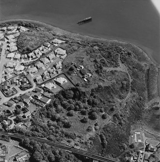 Oblique aerial view of Carlingnose point centred on the remains of a battery and submarine mining station, taken from the WSW.