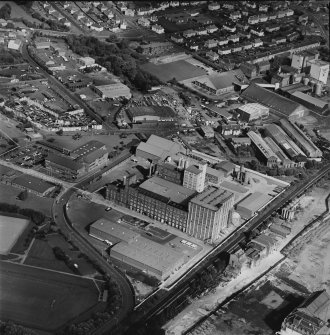 Oblique aerial view centred on the Linoleum works with offices adjacent, taken from the SSW.