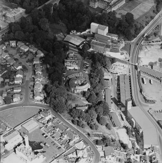 Oblique aerial view centred on the villa with villa, works and flour mill adjacent, taken from the SSW.
