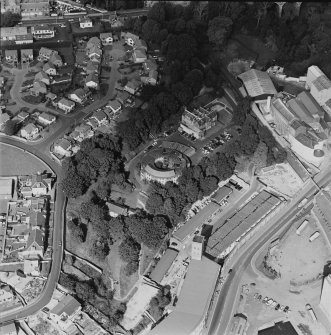 Oblique aerial view centred on the villa with villa, works and flour mill adjacent, taken from the SSE.