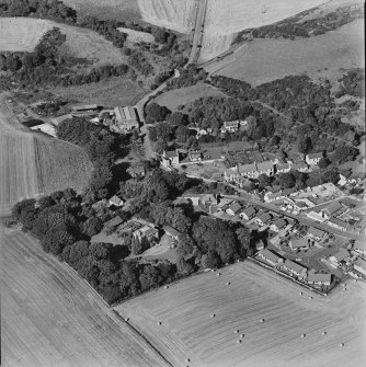 Oblique aerial view centred on the village of Auchtertool with house adjacent, taken from the SSE.