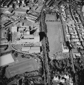 Oblique aerial view centred on the site of the works with the engineering works, foundry and offices and works adjacent, taken from the WSW.