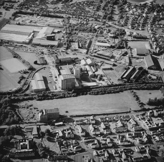 Oblique aerial view centred on the site of the works with the engineering works, foundry and offices, factory and works adjacent, taken from the SSE.