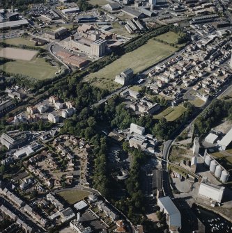 Oblique aerial view centred on the site of the works with the engineering works, foundry and offices, maltings and works adjacent, taken from the S.