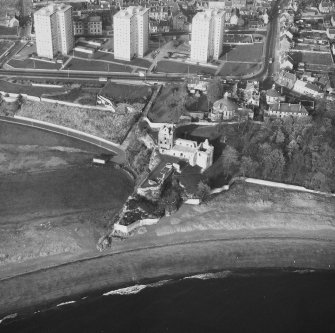 Oblique aerial view from South East of Ravenscraig Castle. Includes Pathhead tower blocks.