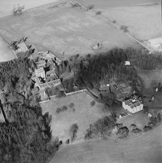 Oblique aerial view of Strathenry House centred on a country house with a dovecot and tower house adjacent, taken from the SSE.
