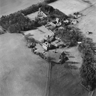 Oblique aerial view of Strathenry House centred on a country house with a dovecot and tower house adjacent, taken from the ESE.