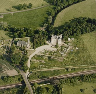 Dairsie Castle, oblique aerial view taken from the NW, centred on the remains of a castle, a church and Dairsie bridge.