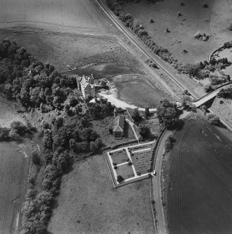 Oblique aerial view of Dairsie Castle and Dairsie Old Church centred on the castle and church, taken from the ENE.
