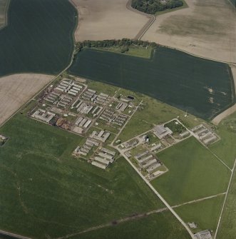 Oblique aerial view centred on the remains of the military camp, taken from the E.