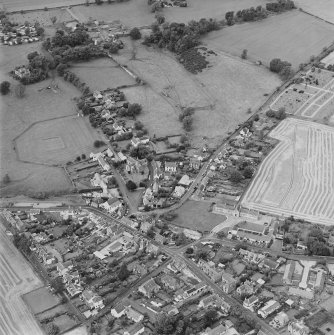 Oblique aerial view centred on the village of Upper Largo with walled garden, tower house and country house adjacent, taken from the E.