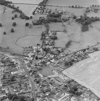 Oblique aerial view centred on the village of Upper Largo with walled garden, tower house and country house adjacent, taken from the ENE.