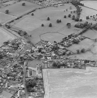 Oblique aerial view centred on the village of Upper Largo with walled garden and country house adjacent, taken from the NE.