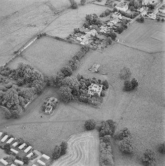 Oblique aerial view centred on the remains of the country house with stables and walled garden adjacent, taken from the WSW.