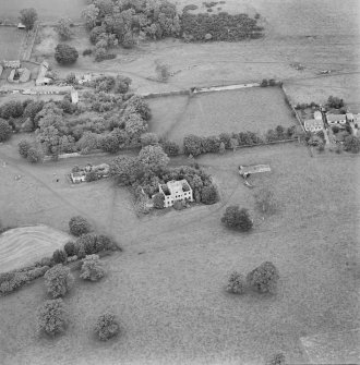 Oblique aerial view centred on the remains of the country house with stables, walled garden, tower house, farmhouse and cottages adjacent, taken from the SSE.