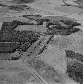 General oblique aerial view looking across the policies of the country house, taken from the SE.