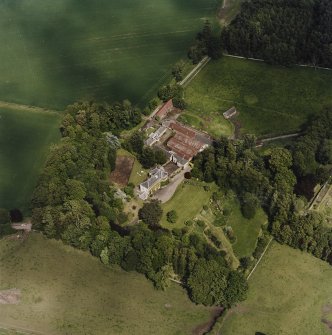 General oblique aerial view looking across the policies of the country house, taken from the SW.