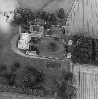 Oblique aerial view centred on the country house, garden, pavilions and lodges, taken from the SW.