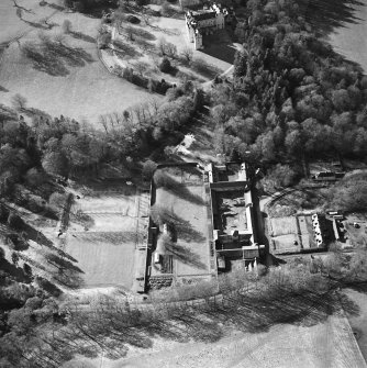 Oblique aerial view centred on the walled garden and farmsteading with castle adjacent, taken from the E.