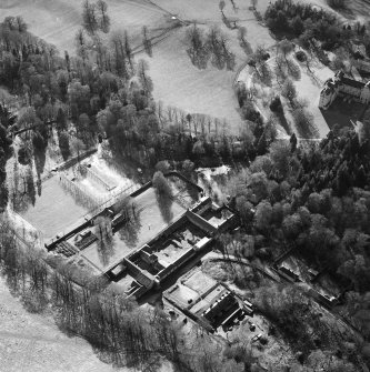 Oblique aerial view centred on the walled garden and farmsteading with castle adjacent, taken from the NE.