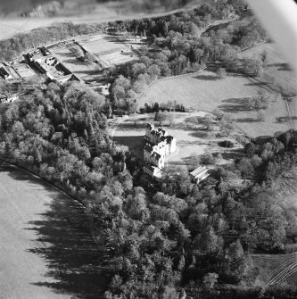 Oblique aerial view centred on the castle with walled garden and farmsteading adjacent, taken from the NW.