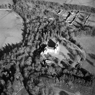 Oblique aerial view centred on the castle with walled garden and farmsteading adjacent, taken from the WSW.