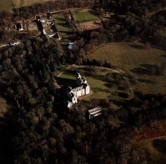 Oblique aerial view centred on the castle with walled garden and farmsteading adjacent, taken from the SW.