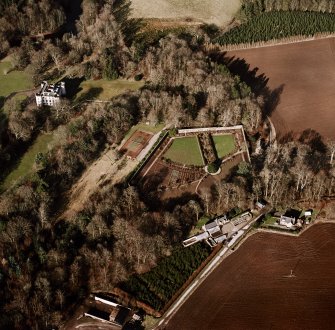 Oblique aerial view centred on the castle and tower-house, taken from the W.