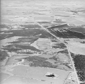 General aerial oblique view of farmsteads and quarry, taken from the WNW.