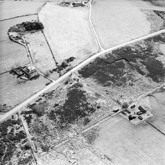 Oblique aerial view centred on the farmsteads, taken from the NE.