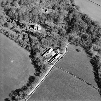 Oblique aerial view centred on the country house and farmsteading, taken from the W.