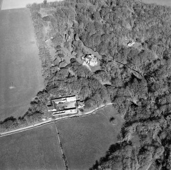 Oblique aerial view centred on the country house and farmsteading, taken from the SW.