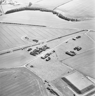 Oblique aerial view centred on the remains of the radar station, and pillboxes, taken from the NE.