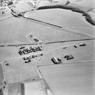 Oblique aerial view centred on the remains of the radar station, and pillboxes, taken from the NNE.