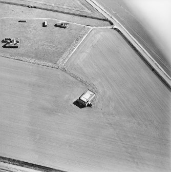 Oblique aerial view centred on the remains of the radar station and building, taken from the NNW.
