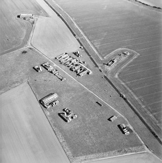Oblique aerial view centred on the remains of the radar station, pillboxes and building, taken from the NW.