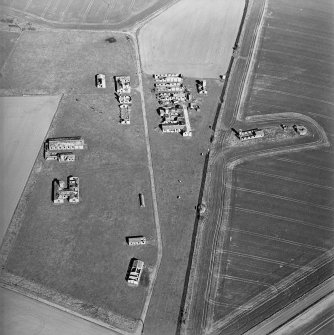 Oblique aerial view centred on the remains of the radar station, and pillboxes, taken from the W.