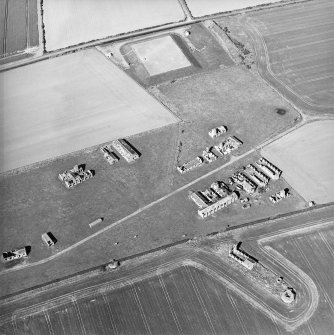 Oblique aerial view centred on the remains of the radar station, and pillboxes, taken from the SW.