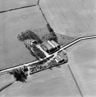 Oblique aerial view centred on the remains of the abbey and the house, taken from the NNW.