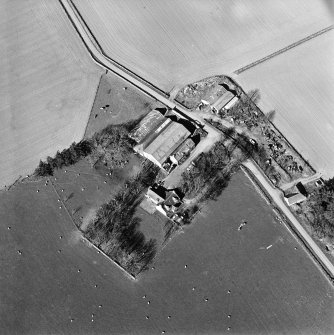 Oblique aerial view centred on the remains of the abbey and the house and walled garden, taken from the WSW.