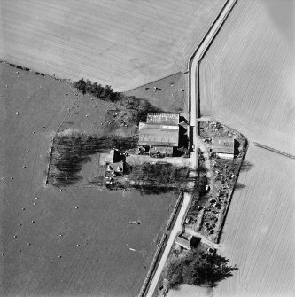 Oblique aerial view centred on the remains of the abbey and the house and walled garden, taken from the SW.