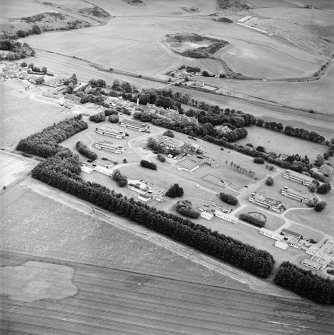 General oblique aerial view of the hospital and the railway station, taken from the NW.