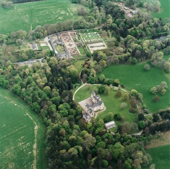 Oblique aerial view centred on Fyvie Castle with walled garden adjacent, taken from the NW.