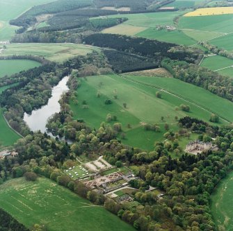 Oblique aerial view centred on Fyvie Castle and policies, with walled garden adjacent, taken from the ENE.