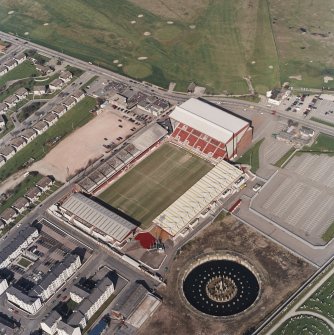 Oblique aerial view centred on the stadium, taken from the SW.