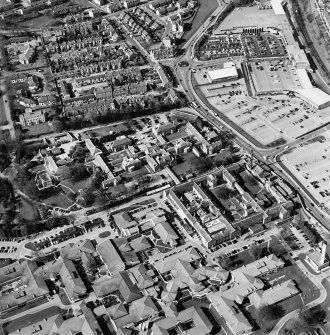 Oblique aerial view centred on the hospital, obelisk, factory and mill, taken from the S.
