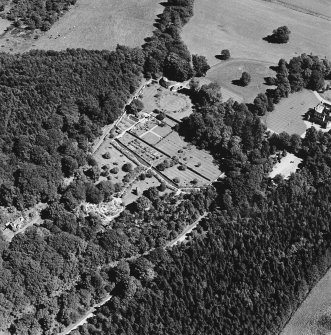 Oblique aerial view of Leith Hall centred on the country house, walled garden and offices, taken from the SW.